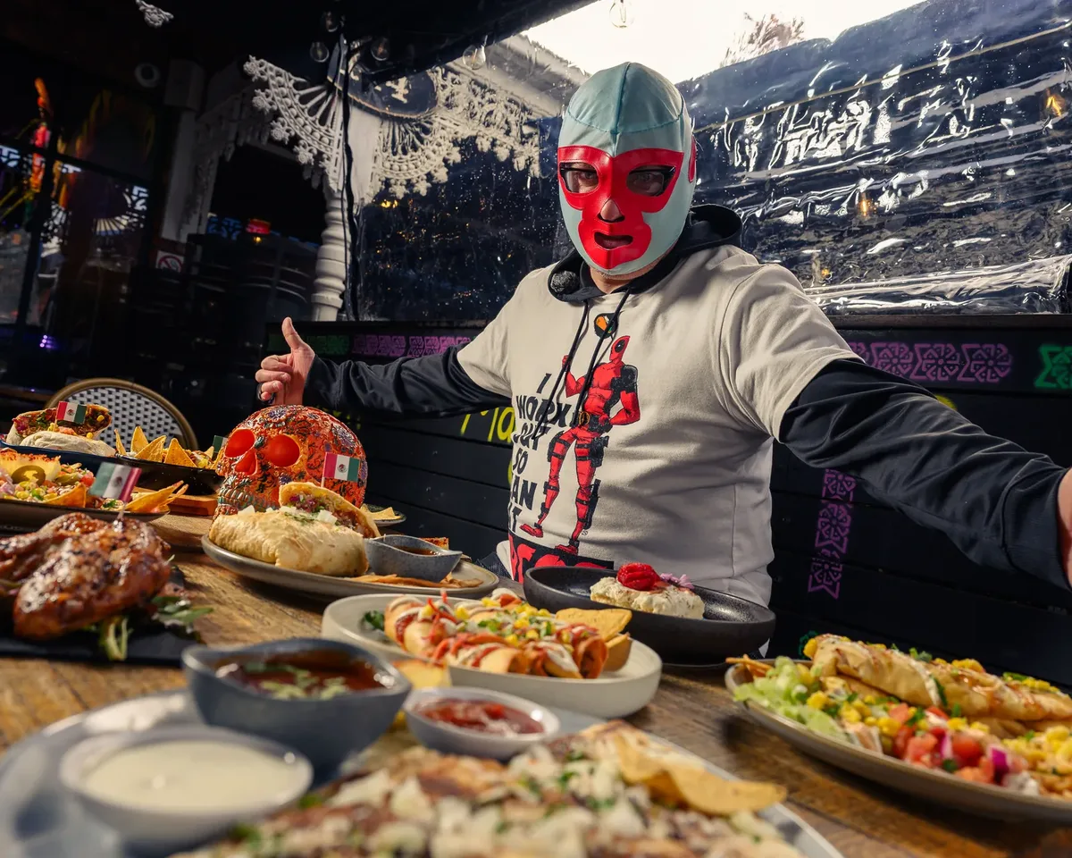 Luchador with a Jarritos soda