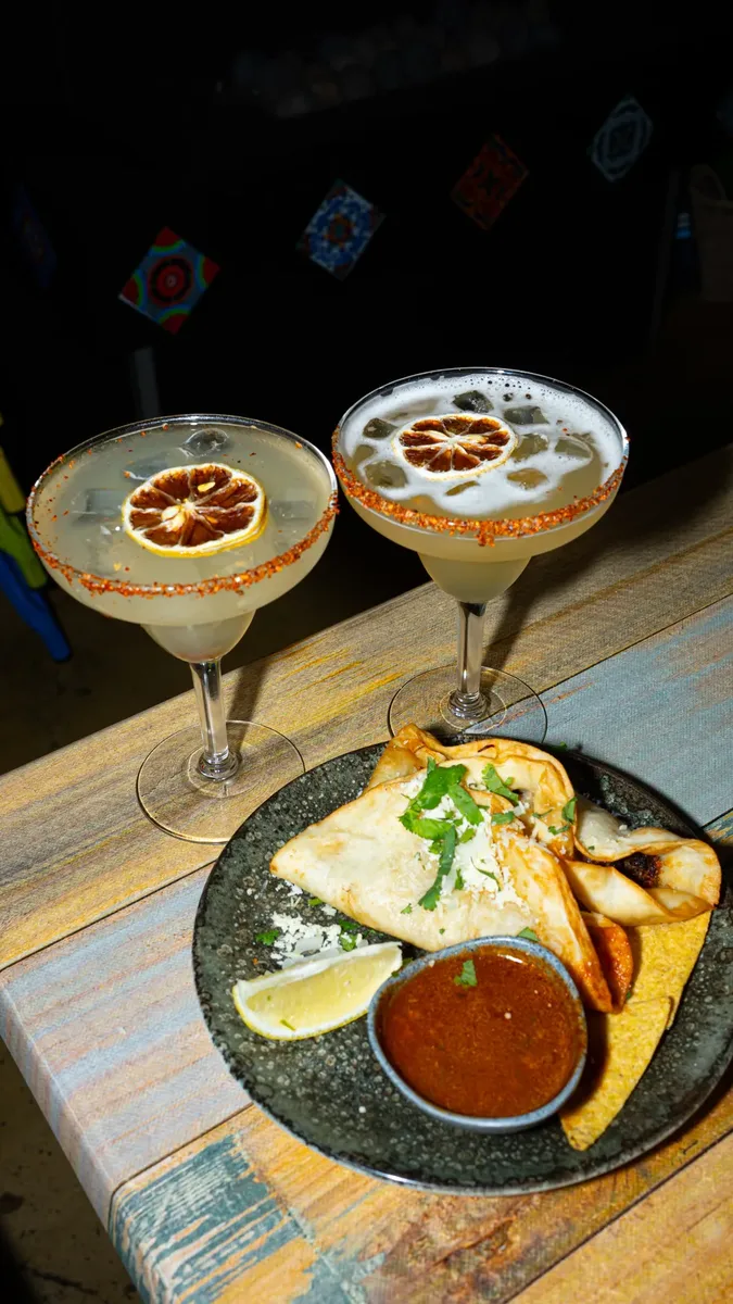 Margaritas and a shared plate on a table