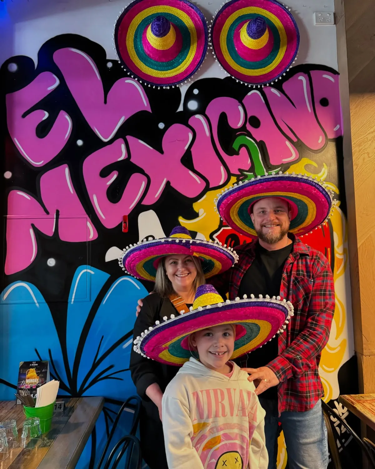 Family in sombreros at El Mexicano mural