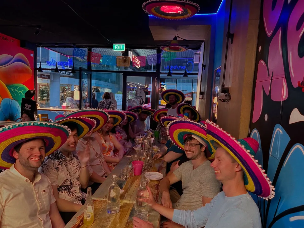 Long table of guests in sombreros at El Mexicano
