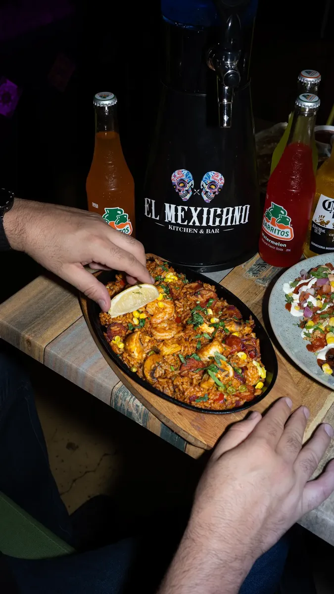 Sizzling paella-style pan straight from the kitchen
